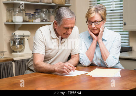 Senior couple working out their bills Stock Photo