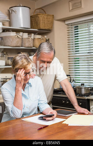 Senior couple working out their bills Stock Photo
