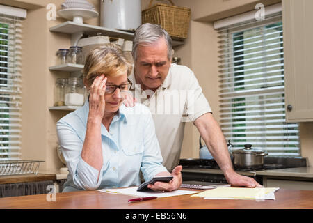 Senior couple working out their bills Stock Photo