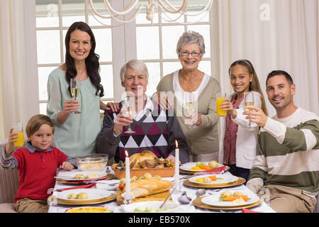 Happy extended family at christmas toasting at camera Stock Photo