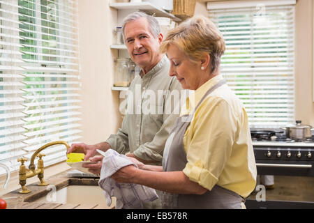 Senior couple washing the dishes Stock Photo