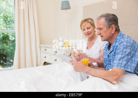 Senior couple having breakfast in bed Stock Photo