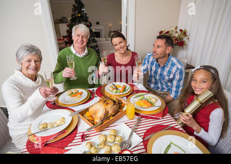 Portrait of happy family toasting at camera Stock Photo