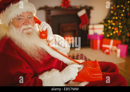 Smiling santa making a phone call Stock Photo