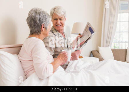 Senior couple relaxing in bed Stock Photo