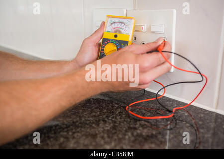 Metering voltage with digital multimeter Stock Photo