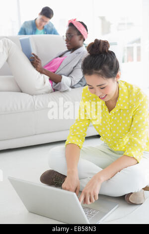 Young creative woman working on floor Stock Photo