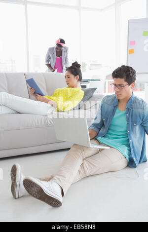 Young creative man working on floor Stock Photo