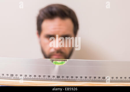 Casual man using spirit level Stock Photo