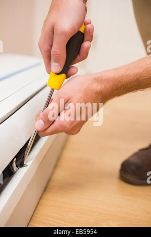 Handyman fixing an air conditioning Stock Photo