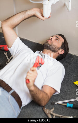 Plumber fixing the sink in a bathroom Stock Photo