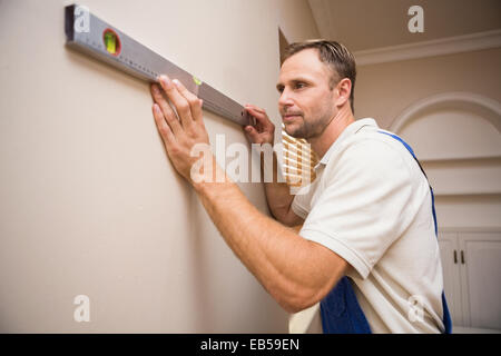 Construction worker using spirit level Stock Photo