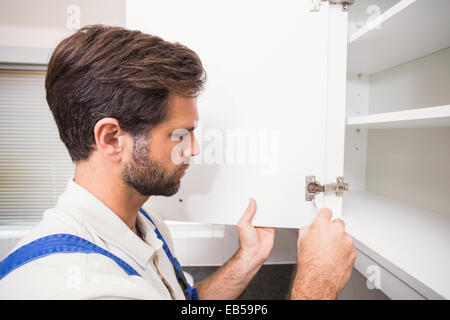 Handyman putting up a shelf Stock Photo