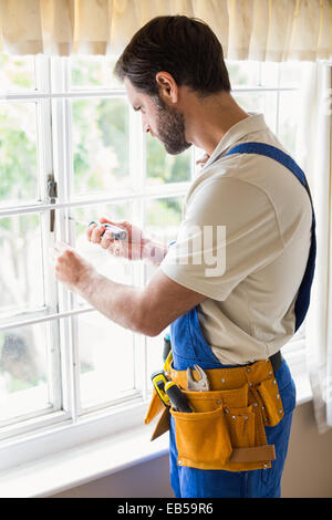 Handyman fixing a window Stock Photo
