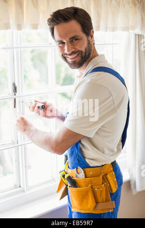 Handyman fixing a window Stock Photo
