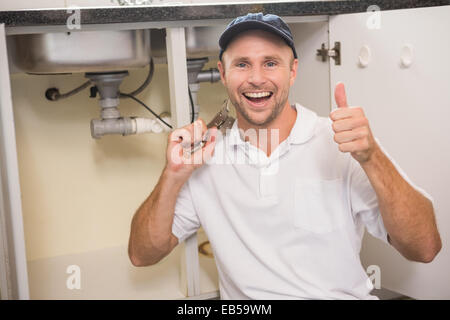 Plumber fixing under the sink Stock Photo