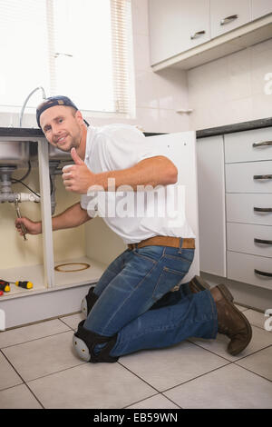 Plumber fixing under the sink Stock Photo
