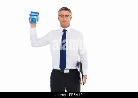 Businessman showing calculator while holding his laptop Stock Photo