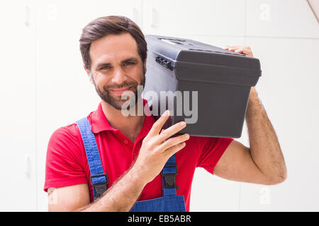Construction worker holding tool box Stock Photo
