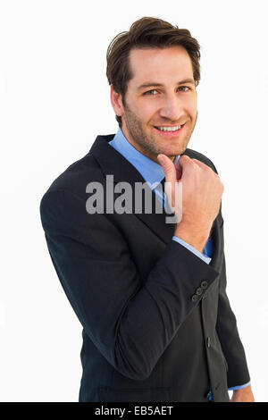 Businessman touching his chin while smiling at camera Stock Photo
