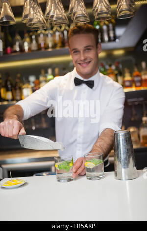 Happy bartender making a cocktail Stock Photo