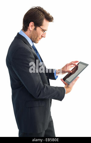 Businessman standing while using a tablet pc Stock Photo