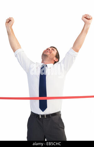 Excited businessman celebrating success with his arms raised up ...