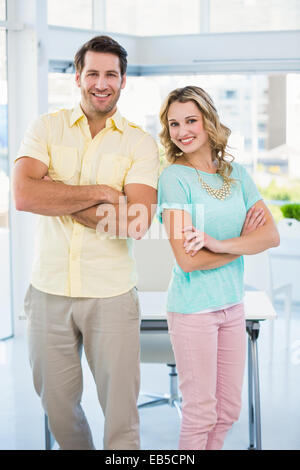 Creative business team posing with arms crossed Stock Photo - Alamy