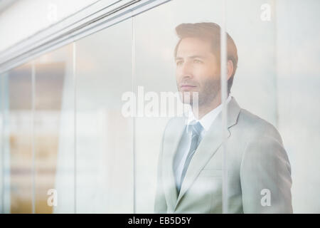 Portrait of thoughtful businessman through the window Stock Photo