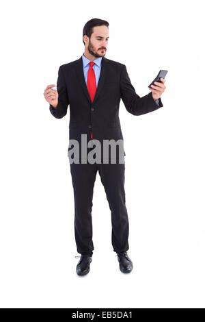 Handsome businessman texting on phone Stock Photo