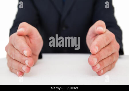 Mid section of a businessman with hands on a table Stock Photo