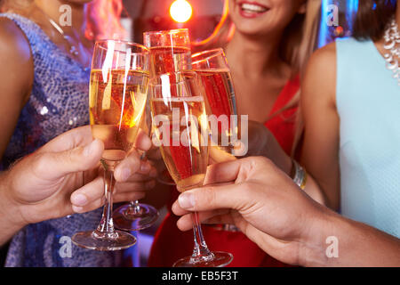 Close-up of hands clinking champagne flutes Stock Photo