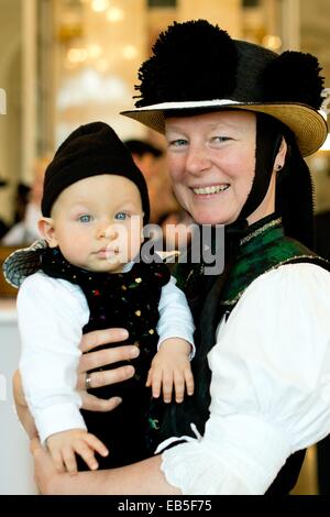 Birgit Santalucia and her son Claudio from the Trachten (traditional costume) association St. Georgen in the Black Forest stand during a reception held by the state government in Stuttgart, Germany, 26 November 2014. The German Trachten Association has named the costumes from the St. Georgen Parish as Tracht of the Year 2014. Photo: SEBASTIAN KAHNERT/dpa Stock Photo