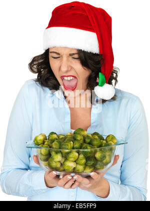 Young Woman Holding A Bowl Of Freshly Cooked Brussel Sprouts Vegetables Isolated Against A White Background Ready To Eat With A Clipping path Stock Photo