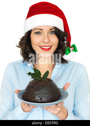 Young Woman in a Christmas Santa Hat Holding Traditional Christmas Pudding Stock Photo