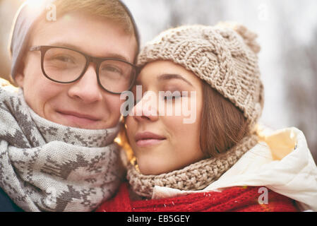 Faces of cute young dates in casual winterwear Stock Photo