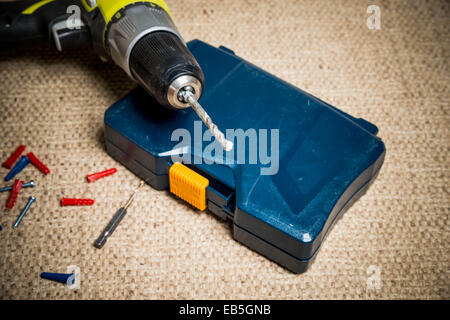 Portable drill in dusty workshop Stock Photo