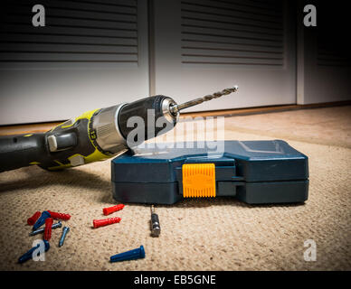 Portable drill in dusty workshop Stock Photo