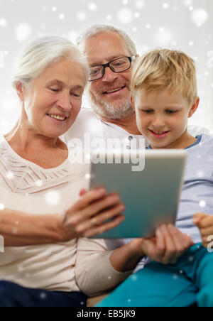 smiling family with tablet pc at home Stock Photo