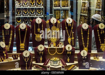 Gold jewelries displayed in a store window. Souq Muttrah, Muscat, Oman. Stock Photo