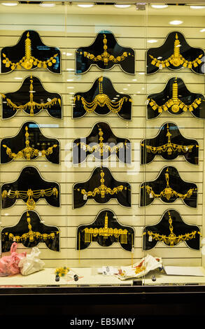 Gold jewelries displayed in a store window. Souq Muttrah, Muscat, Oman. Stock Photo