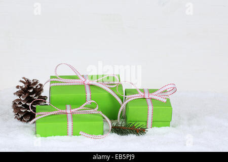 Christmas gifts in boxes with snow on wooden background and copyspace Stock Photo