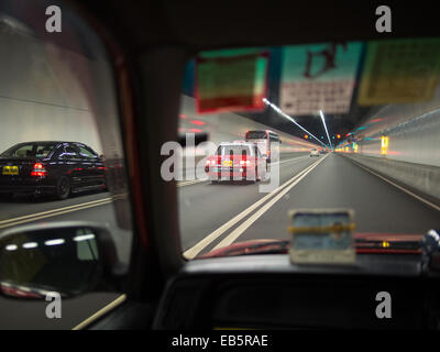 Fast taxi ride through a tunnel in Hong Kong Stock Photo