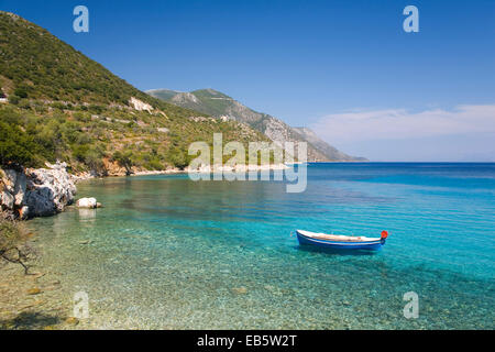 Vathy, Ithaca, Ionian Islands, Greece. View from shore across the turquoise waters of the Gulf of Molos, small boat at anchor. Stock Photo