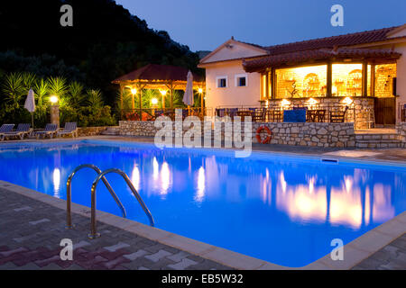 Frikes, Ithaca, Ionian Islands, Greece. Inviting swimming pool illuminated by night. Stock Photo
