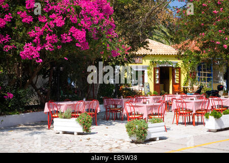 Asos, Kefalonia, Ionian Islands, Greece. Colourful taverna in the village square, bougainvillea prominent. Stock Photo