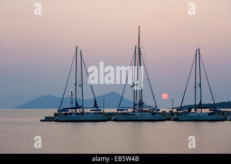 Frikes, Ithaca, Ionian Islands, Greece. View across the harbour at sunrise, the distant island of Atokos visible. Stock Photo