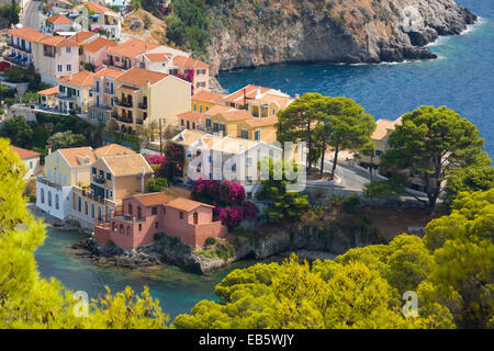 Asos, Kefalonia, Ionian Islands, Greece. View from hillside to pastel-coloured houses on isthmus above the harbour. Stock Photo