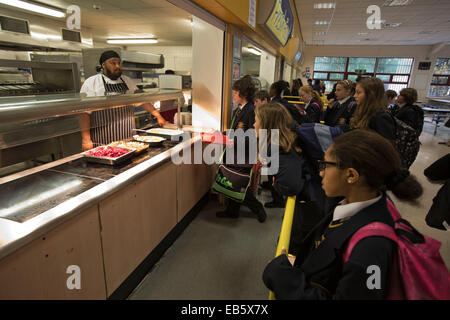 Pupils from Loreto High School in Chorlton, south Manchester, lining up to be served a school dinner by top chef Sukhdev Singh. Stock Photo