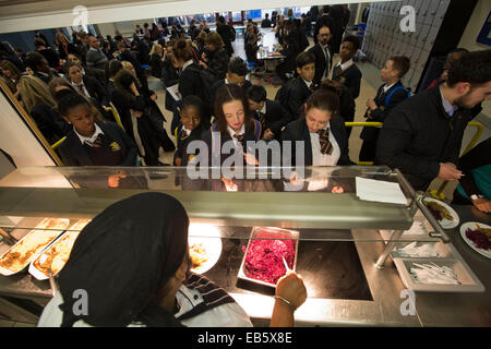 Pupils from Loreto High School in Chorlton, south Manchester, lining up to be served a school dinner by top chef Sukhdev Singh. Stock Photo